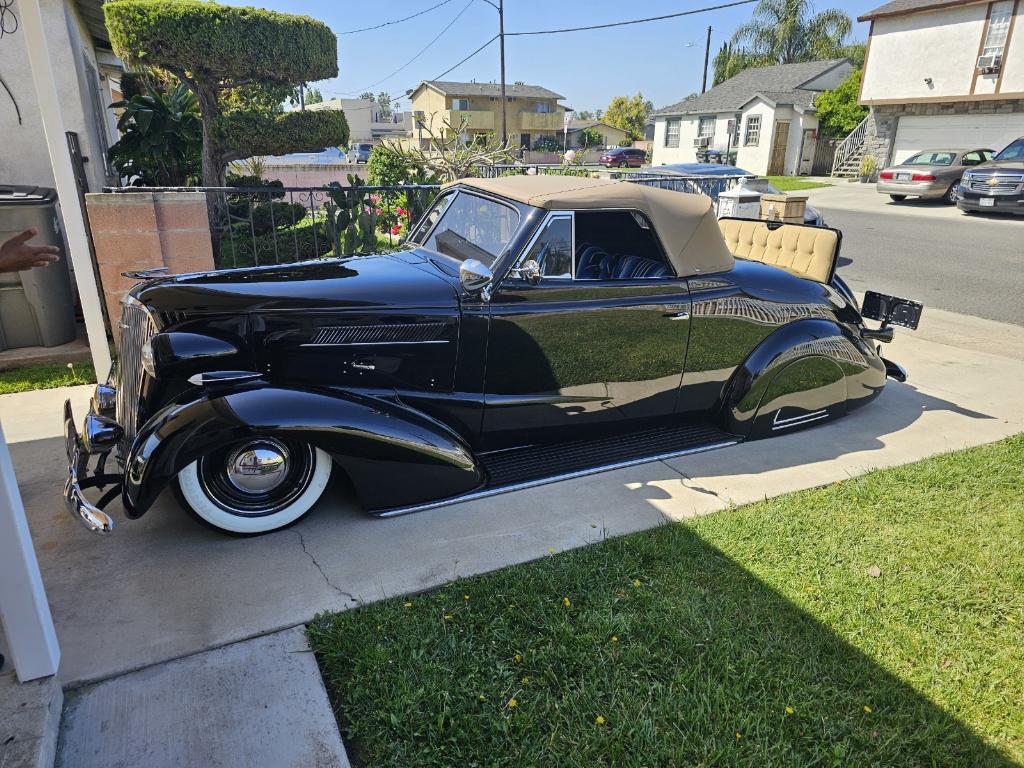Black custom convertible parked outside.