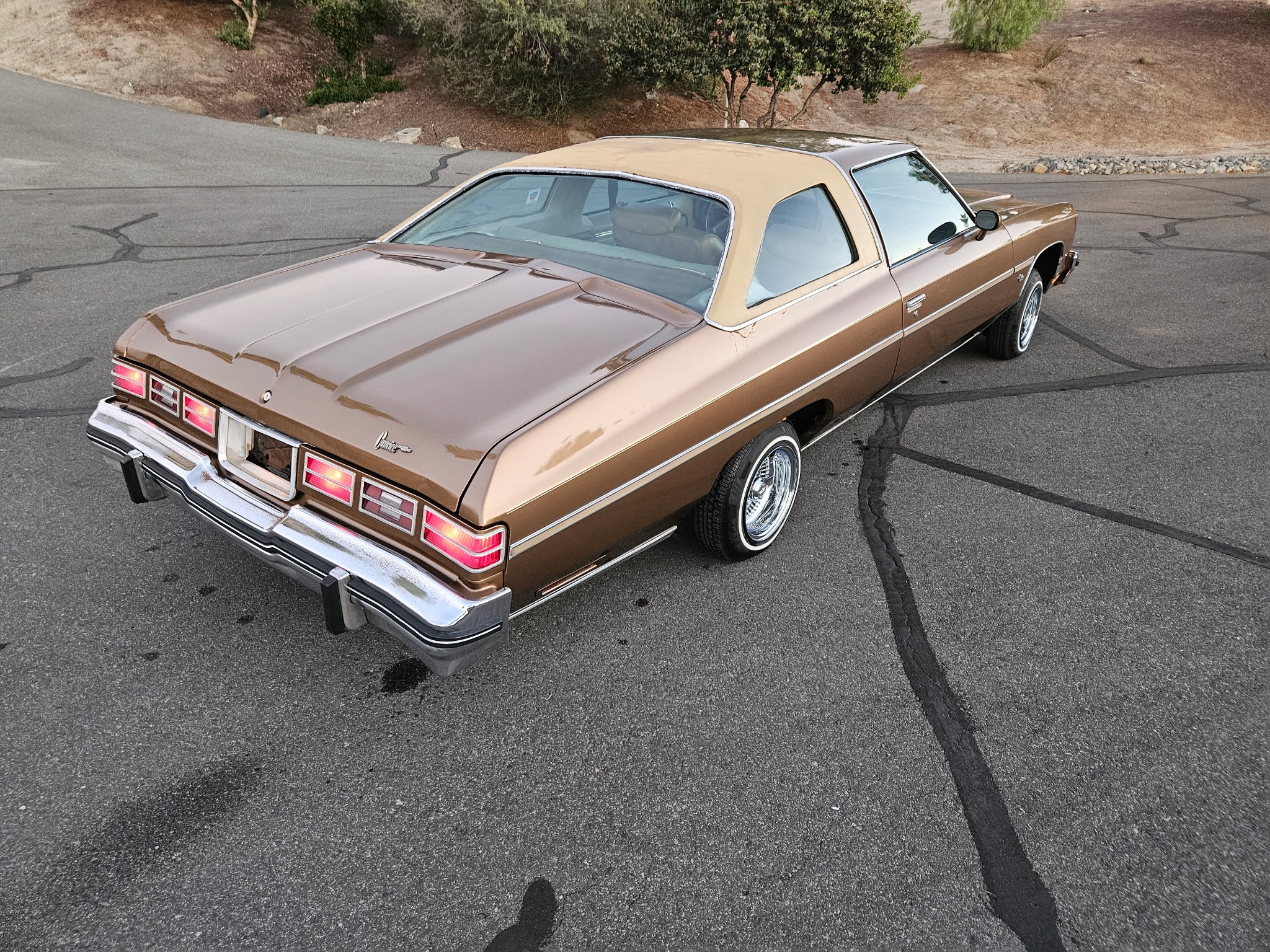 Brown Chevrolet Impala rear quarter.